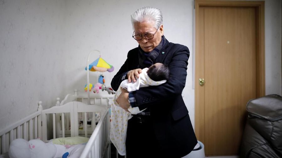 Kim Mi-sung checks her daughter's homework before leaving for school, at their home in Seoul, South Korea, December 19, 2018. Picture taken December 19, 2018. REUTERS/Kim Hong-Ji