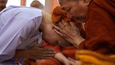 Boodsabann menangis ketika dia menjalani prosesi dan bersiap mengganti busana putihnya dengan jubah kuning khas biarawan pria. (REUTERS/Athit Perawongmetha)