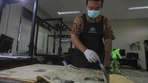 Pegawai bagian konservasi preservasi membersihkan koleksi surat kabar saat proses digitalisasi di Monumen Pers Nasional Solo, Jawa Tengah. (ANTARA FOTO/Maulana Surya)