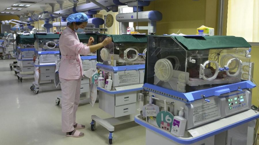In this Jan. 19, 2019, photo, a nurse checks on the new-born babies under intensive care at a hospital in Fuyang in central China's Anhui province. China's population rose by 15.23 million people in 2018, marking a continued decrease in the growth rate of the world's most populous nation. (Chinatopix via AP)