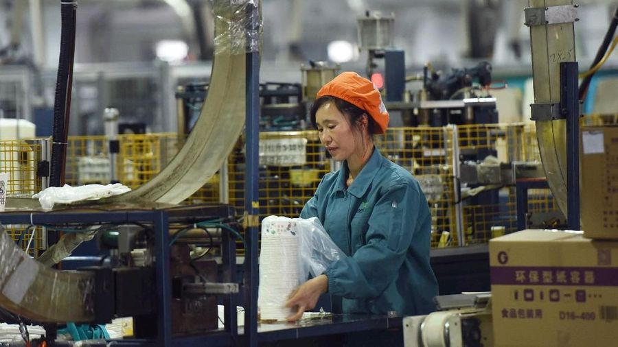 A woman works on a production line manufacturing paper tableware at a factory in Hangzhou, Zhejiang province, China January 21, 2019. REUTERS/Stringer ATTENTION EDITORS - THIS IMAGE WAS PROVIDED BY A THIRD PARTY. CHINA OUT.