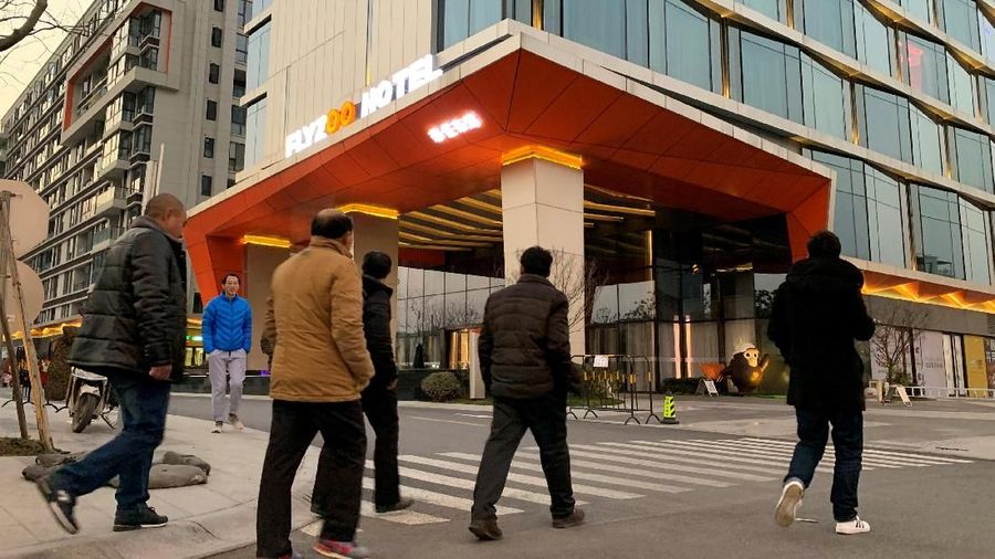 Men walk past Alibaba Group's futuristic FlyZoo hotel in Hangzhou, Zhejiang province, China January 22, 2019. REUTERS/Xihao Jiang