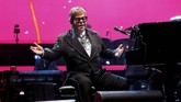 Confetti berwarna-warni bagai jatuh dari langit dengan latar belakang warna merah muda magenta, merayakan akhir konser dan perjalanan karier seorang Sir Elton John. (REUTERS/Mario Anzuoni)