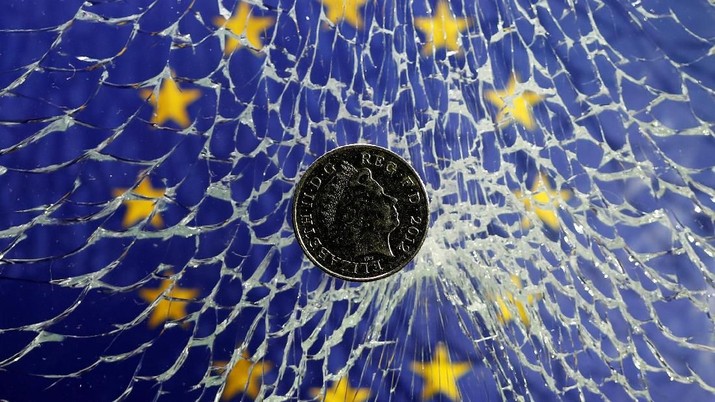 A pound coin is placed on broken glass and EU flag in this illustration picture taken January 28, 2019. REUTERS/Dado Ruvic/Illustration
