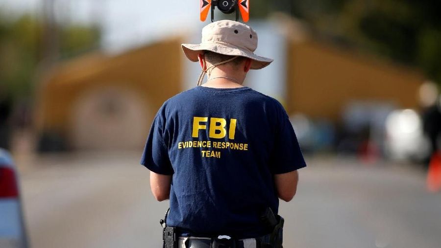 An FBI agent investigates the site of the shooting at the First Baptist Church of Sutherland Springs, Texas, U.S., November 7, 2017. REUTERS/Jonathan Bachman