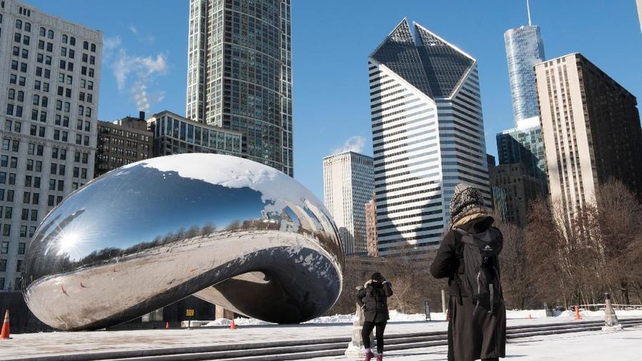 Veronica Perez poses for a portrait in front of the Cloud Gate as her sister Karena Perez takes her picture at Millenium Park during subzero temperatures carried by the polar vortex, in Chicago, Illinois, U.S., January 30, 2019.   REUTERS/Pinar Istek