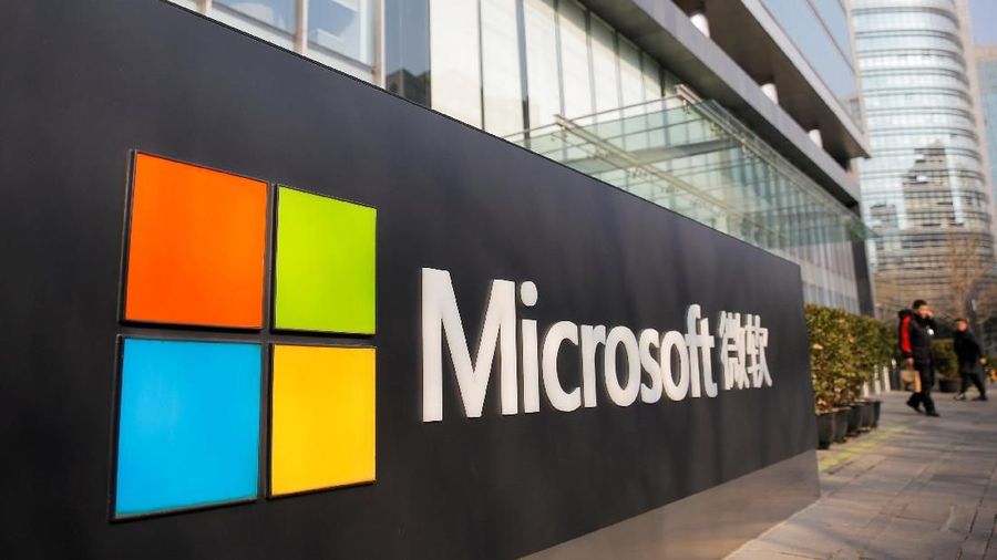 FILE PHOTO: FILE PHOTO: People walk outside the Microsoft office in Beijing, China, January 24, 2019.   REUTERS/Thomas Peter - RC1AF7046AD0/File Photo/File Photo