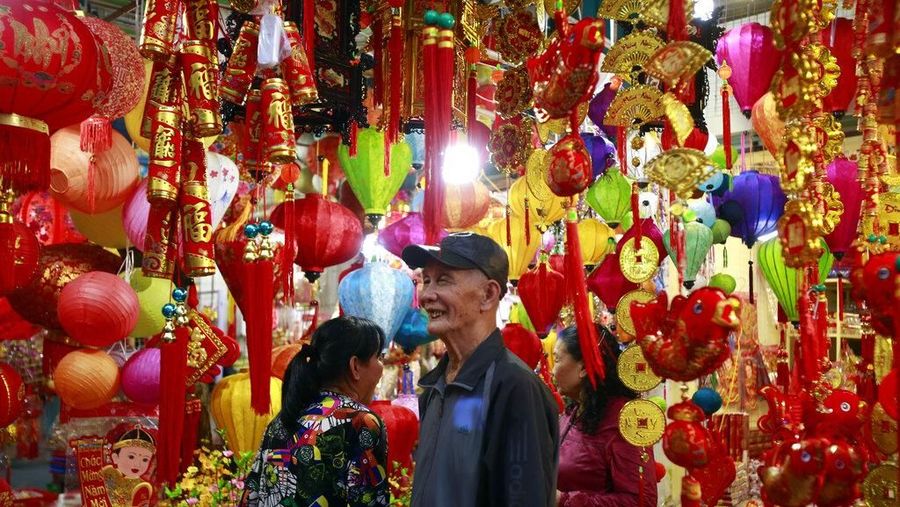 In this Sunday, Feb. 3, 2019, photo, people shop for decorative ornaments in Hanoi, Vietnam. Vietnam is celebrating the Lunar New Year of the Pig, the biggest annual festival of the year. (AP Photo/Hau Dinh)