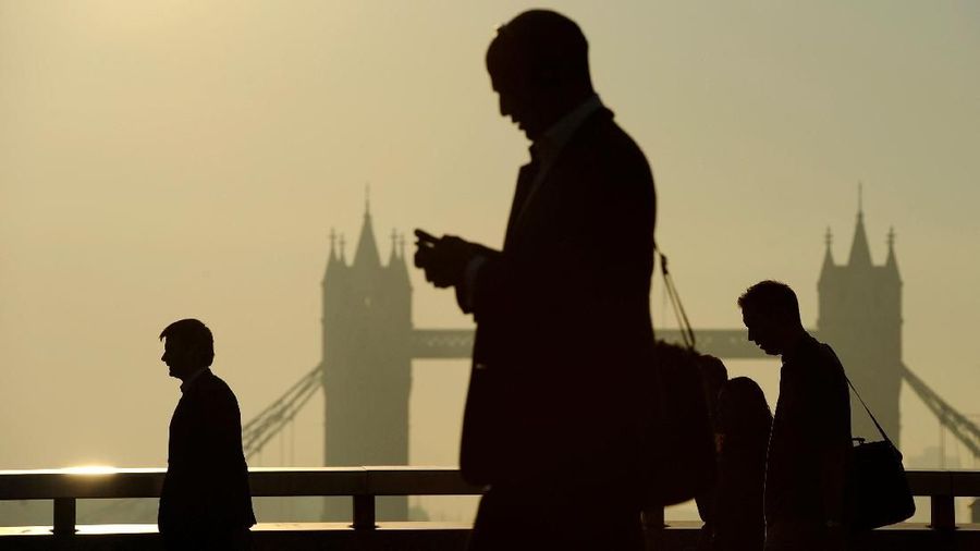 FILE PHOTO: Workers cross London Bridge, with Tower Bridge seen behind, during the morning rush hour in London September 30, 2011. REUTERS/Paul Hackett /File Photo GLOBAL BUSINESS WEEK AHEAD