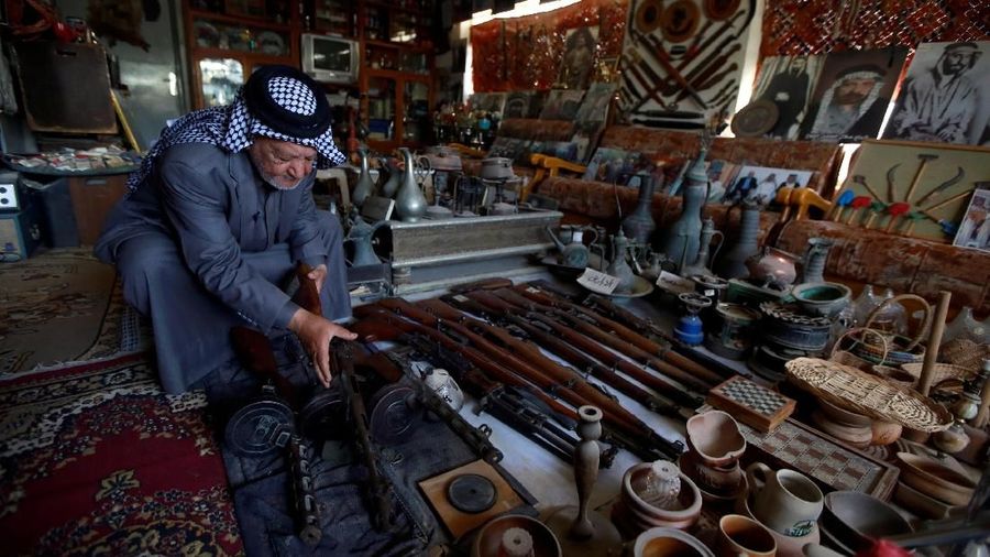 Youssef Akkar, 80, an Iraqi retired teacher holds an old weapon in his museum at home in Najaf, Iraq February 21, 2019. Picture taken February 21, 2019. REUTERS/ Alaa al-Marjani
