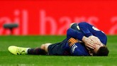 Ketegangan terjadi di pengujung babak pertama setelah Lionel Messi disikut kapten Real Madrid Sergio Ramos. Terlihat Messi terkapar usai disikut. (REUTERS/Juan Medina)