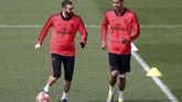 Karim Benzema dan Raphael Varane berbicara saat latihan. Keduanya akan menjadi andalan Real Madrid saat melawan Ajax Amsterdam. (REUTERS/Sergio Perez)