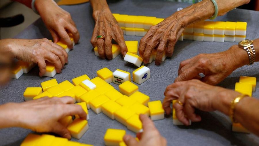 Hawker Leong Yuet Meng, 90, of Nam Seng Noodle House, enjoys her weekly game of Mahjong with her friends at home in Singapore February 16, 2019. Picture taken February 16, 2019. REUTERS/Edgar Su