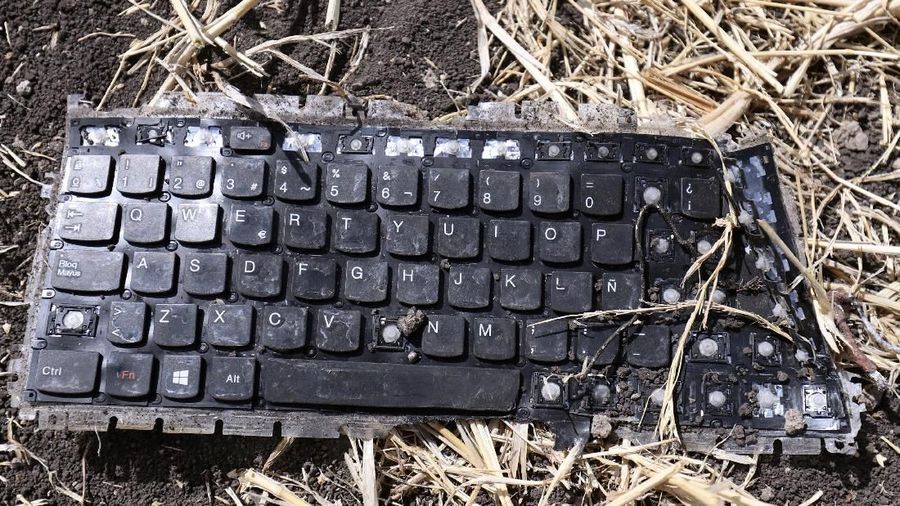A laptop keyboard is seen at the scene of the Ethiopian Airlines Flight ET 302 plane crash, near the town of Bishoftu, southeast of Addis Ababa, Ethiopia March 11, 2019. REUTERS/Tiksa Negeri