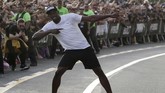 Gaya khas Usain Bolt di setiap kejuaraan lari dunia maupun Olimpiade ketika merayakan kemenangannya. (REUTERS/Henry Romero)