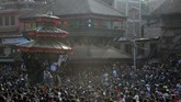 Bhairawa dan Bhadrakali yang ditempatkan dalam kereta besar, ditarik melalui kerumunan orang yang bersorak. Dalam istilah lokal, kereta penarik disebut sebagai Rathas. (AP Photo/Niranjan Shrestha)