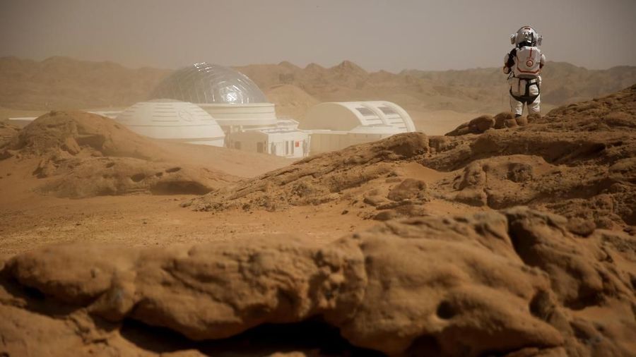 A staff member wearing a mock space suit poses in the Gobi Desert near the C-Space Project Mars simulation base outside Jinchang, Gansu Province, China, April 18, 2019.  REUTERS/Thomas Peter