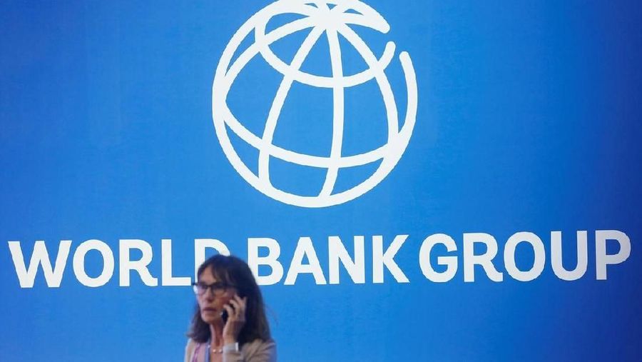 A participant stands near a logo of World Bank at the International Monetary Fund - World Bank Annual Meeting 2018 in Nusa Dua, Bali, Indonesia, October 12, 2018. REUTERS/Johannes P. Christo/File Photo