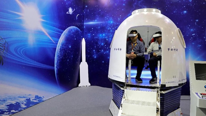 People wear virtual reality (VR) goggles at an exhibition to mark China's Space Day 2019 on April 24, in Changsha, Hunan province, China, April 23, 2019. REUTERS/Aly Song