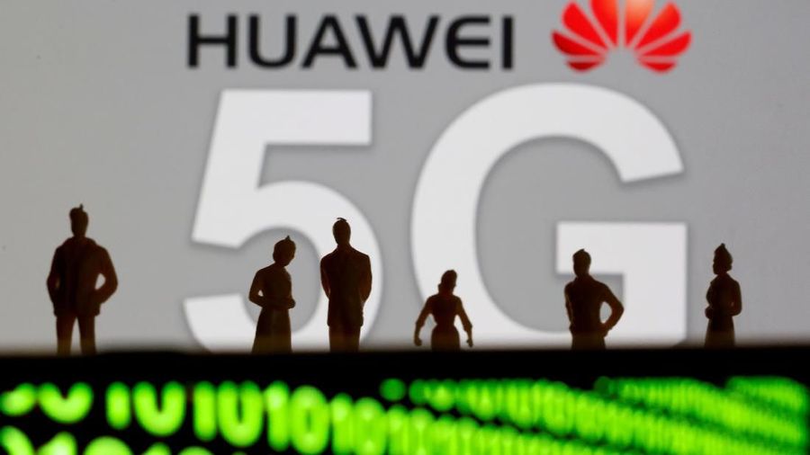 FILE PHOTO: Small toy figures are seen in front of a displayed Huawei and 5G network logo in this illustration picture, March 30, 2019. REUTERS/Dado Ruvic/Illustration/File Photo