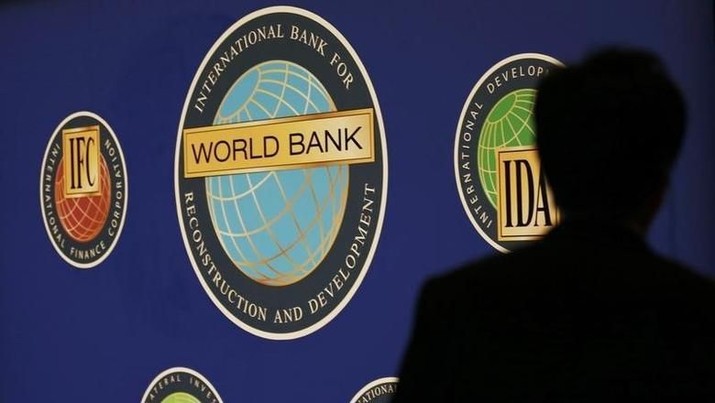 World Bank A man is silhouetted against the logo of the World Bank at the main venue for the International Monetary Fund (IMF) and World Bank annual meeting in Tokyo October 10, 2012. REUTERS/Kim Kyung-Hoon