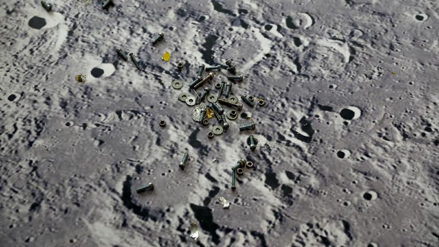 Screws lie on the floor decorated with an image of the lunar surface ahead of an exhibition of China's Space Day 2019, in Changsha, Hunan province, China, April 22, 2019. REUTERS/Aly Song   SEARCH 