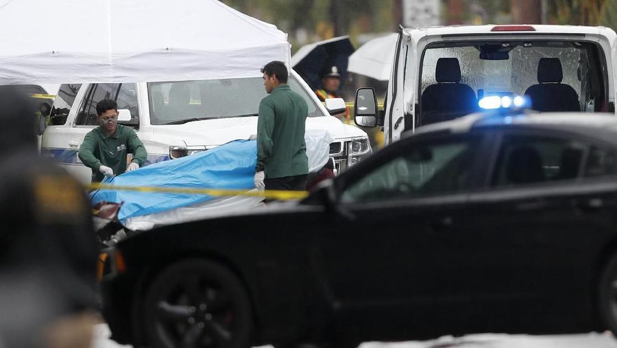 Pejabat memindahkan mayat dari puing-puing helikopter, Senin, 29 April 2019, di Kailua, Hawaii. Api dan bagian-bagian helikopter menghujani langit pada Senin di sebuah komunitas pinggiran kota Honolulu ketika sebuah helikopter tur jatuh dan menewaskan ketiga orang di atas kapal, kata para pejabat dan saksi mata. (AP / Marco Garcia)