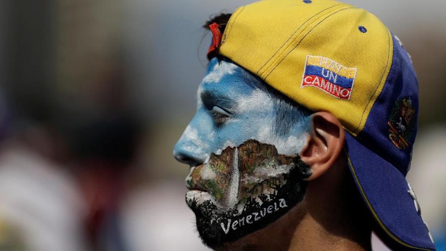 An opposition supporter with his face painted is seen during a rally against the government of Venezuela's President Nicolas Maduro and to commemorate May Day in Caracas Venezuela, May 1, 2019. REUTERS/Ueslei Marcelino