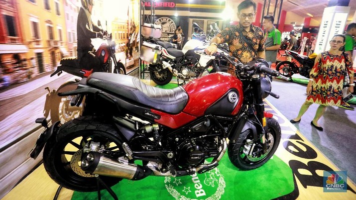 Pengunjung melihat motor Royal Enfield Classic 500 yang di pamerkan dalam gelaran Indonesia International Motor Show 2019 di JIExpo, Jakarta, Jumat (3/5/2019). Motor klasik retro dengab kapasitas mesin 500 cc ini dijual seharga Rp 98.400.000, harga tersebut sudah on the road untuk wilayah Jakarta.Motor ini ditopang oleh rangka single downtube dengan  lonjakan torsi besar, 41.3Nm, dapat dihasilkan pada 4.000 rpm. (CNBC Indonesia/Andrean Kristianto)