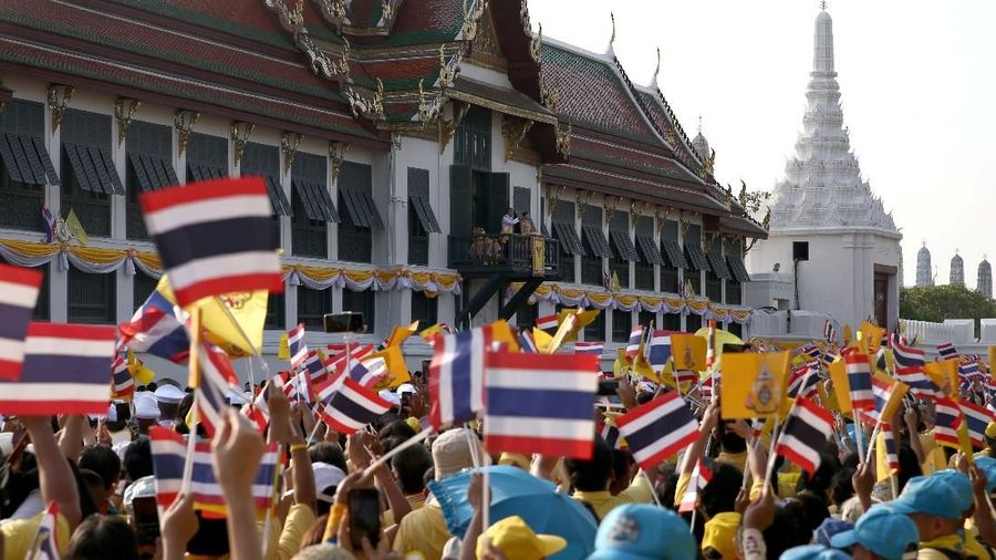 People celebrate outside the balcony of Suddhaisavarya Prasad Hall at the Grand Palace where Thailand's newly crowned King Maha Vajiralongkorn grants a public audience to receive the good wishes of the people in Bangkok, Thailand May 6, 2019.REUTERS/Athit Perawongmetha