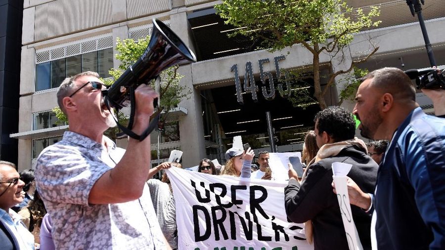 Protestors march through the financial district, demanding fair wages and more transparency during a strike against Uber in San Francisco, California, U.S., May 8, 2019.   REUTERS/Kate Munsch