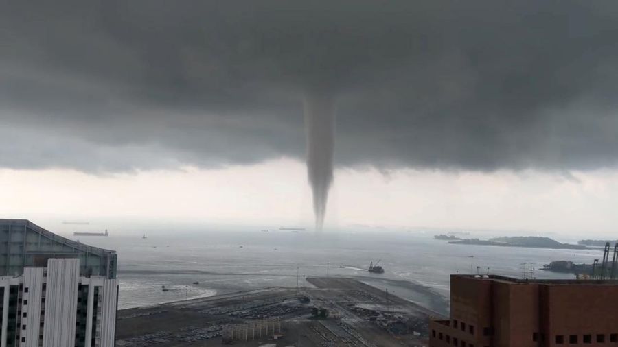 Boats sail near a swirling waterspout in Singapore May 11, 2019, in this picture obtained from social media. Mandatory Credit YouTube Ð Mathieu Sneep/via REUTERS THIS IMAGE HAS BEEN SUPPLIED BY A THIRD PARTY. MANDATORY CREDIT. NO RESALES. NO ARCHIVES.