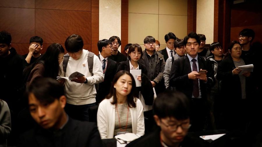 Jobseekers look at recruitment advertisements during the 2018 Japan Job Fair in Seoul, South Korea, November 7, 2018. Picture taken on November 7, 2018. To match Insight SOUTHKOREA-JOBS/KMOVE  REUTERS/Kim Hong-Ji