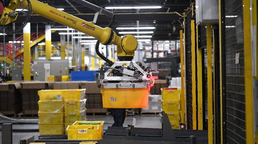 A 6-axis robotic arm picks up sorting containers at the Amazon fulfillment center in Baltimore, Maryland, U.S., April 30, 2019. REUTERS/Clodagh Kilcoyne