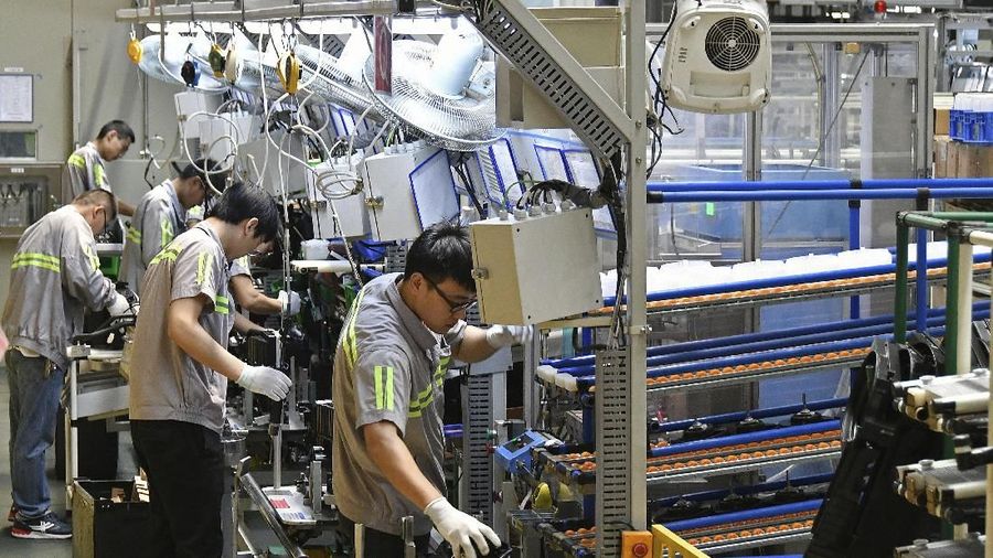 Factory workers are seen on an assembly line at a manufacturing plant for automobile air conditioners in Yantai in eastern China's Shandong province, Wednesday, May 15, 2019. China's factory output and consumer spending weakened in April as a tariff war with Washington intensified, stepping up pressure on Beijing to shore up economic growth. (Chinatopix via AP)