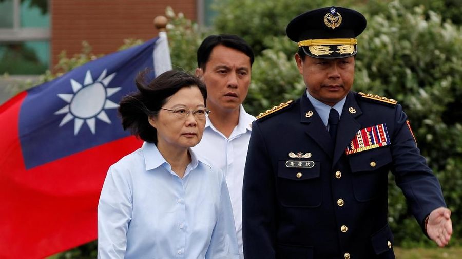 Taiwan President Tsai Ing-wen walks past a national flag before Hai-an No. 10 maritime exercises, simulating fending off terror attacks and invasion at Taipei Port, New Taipei City, Taiwan May 4, 2019. REUTERS/Tyrone Siu
