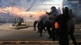 Tembakan gas air mata dibalas massa dengan lemparan batu dan petasan. Namun tidak menyurutkan langkah petugas untuk mendesak pelaku yang mundur hingga Pasar Tanah Abang. (BAY ISMOYO/AFP)