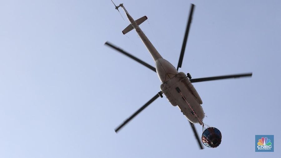 Helikopter Kementerian Perhubungan menyiram massa di kawasan KS Tubun, Jakarta, Rabu (22/5). Pihak berwajib membubarkan massa dengan helikopter.