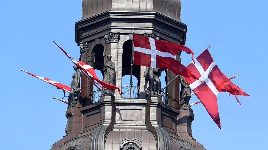 Danish flags flutter on top of the Parliament during the Danish general election in Copenhagen, Denmark, June 5, 2019. REUTERS/Fabian Bimmer