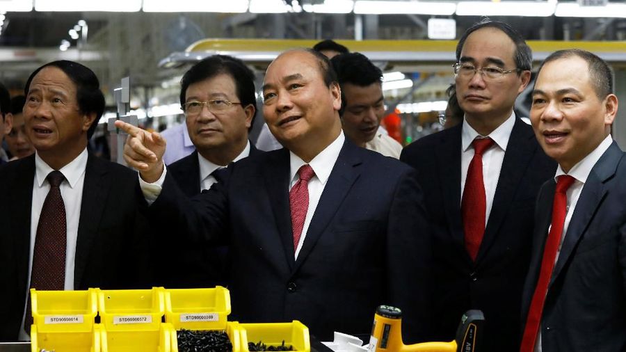 Vingroup's chairman Pham Nhat Vuong guides Vietnam's Prime Minister Nguyen Xuan Phuc during a tour to Vinfast auto plant on the occasion of its opening ceremony in Hai Phong city, Vietnam June 14, 2019. REUTERS/Kham