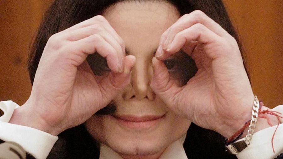 FILE PHOTO: Pop star Michael Jackson jokes with the photographer during a break in his testimony in Santa Maria, California, December 3, 2002. REUTERS/Jim Ruymen/File Photo PLEASE SEARCH