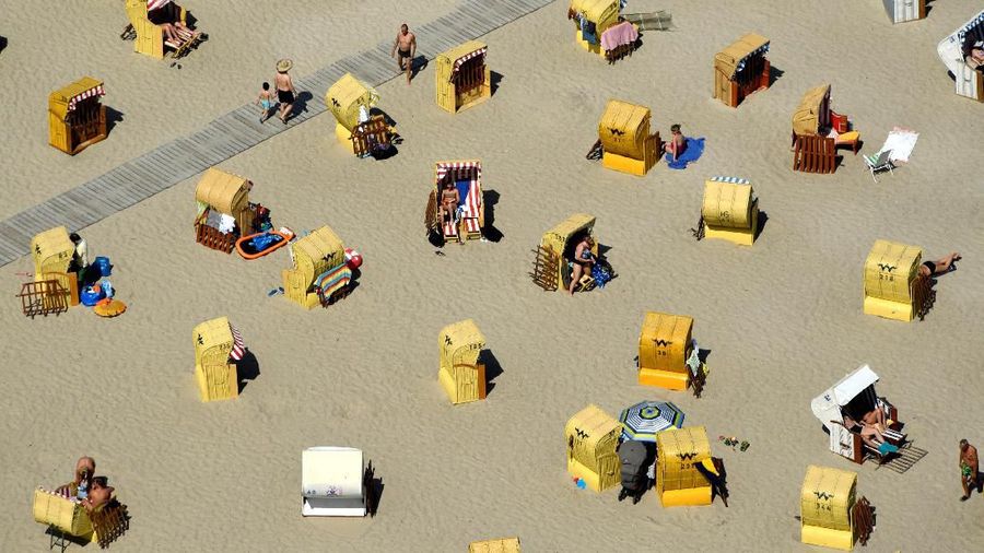 People enjoy sunbathing at a beach by the Baltic Sea in Travemuende, Germany, June 30, 2019. REUTERS/Fabian Bimmer TPX IMAGES OF THE DAY