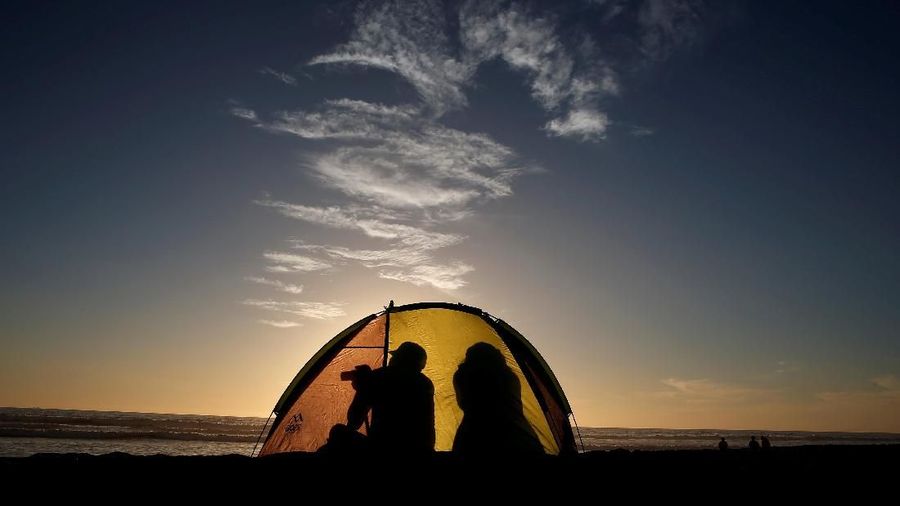 A man take a picture inside of his tent during the sunset in a beach at La Serena, Chile June 30, 2019. REUTERS/Rodrigo Garrido     TPX IMAGES OF THE DAY