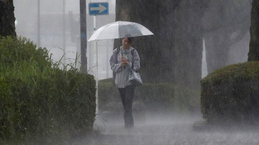A pedestrian walks through heavy rain in Kirishima, Kagoshima Prefecture, southwestern Japan, July 3, 2019, in this photo taken by Kyodo. Mandatory credit Kyodo/via REUTERS ATTENTION EDITORS - THIS IMAGE WAS PROVIDED BY A THIRD PARTY. MANDATORY CREDIT. JAPAN OUT. NO COMMERCIAL OR EDITORIAL SALES IN JAPAN. THIS IMAGE WAS PROCESSED BY REUTERS TO ENHANCE QUALITY, AN UNPROCESSED VERSION HAS BEEN PROVIDED SEPARATELY.