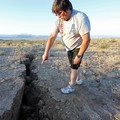 A man looks into a fissure that opened in the desert during a powerful earthquake that struck Southern California, near the city of Ridgecrest, California, U.S., July 4, 2019. REUTERS/David McNew