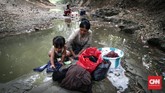 Warga Desa Ridogalih mencuci pakaian dan mandi di Kali Cihoe Desa Ridogalih, Cibarusa, Kabupaten Bekasi. Kemarau membuat sumur di rumah kering. (CNNIndonesia/Safir Makki)