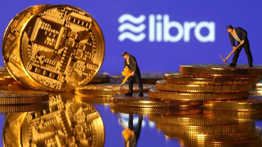 FILE PHOTO: Small toy figures are seen on representations of virtual currency in front of the Libra logo in this illustration picture, June 21, 2019. REUTERS/Dado Ruvic/Illustration/File Photo