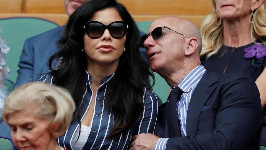 Tennis - Wimbledon - All England Lawn Tennis and Croquet Club, London, Britain - July 14, 2019 Amazon CEO Jeff Bezos and his girlfriend TV presenter Lauren Sanchez in the Royal Box during the final between Switzerland's Roger Federer and Serbia's Novak Djokovic Adrian Dennis/Pool via REUTERS