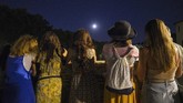 Ketika memasuki bayangan Bumi, Bulan kehilangan cahaya pantulan dari Matahari dan menyebabkan sebagian permukaannya tampak gelap. (AP Photo/Andrew Medichini)