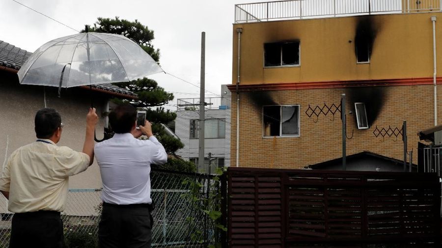 A man takes photos of the torched Kyoto Animation building after an arson attack in Kyoto, Japan, July 19, 2019. REUTERS/Kim Kyung-Hoon